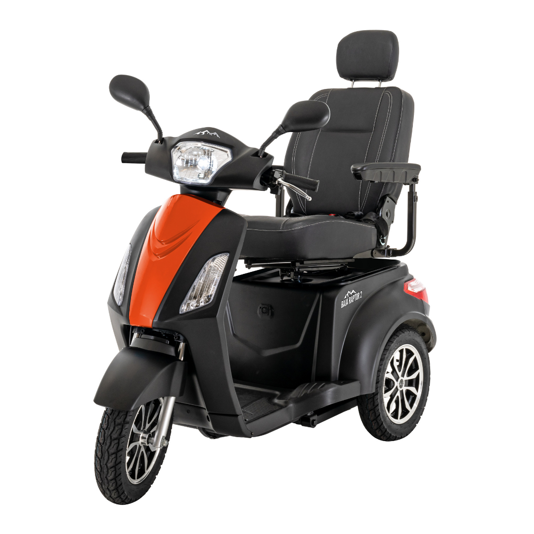 The Pride Baja® Raptor® 2 Bariatric 3-Wheel Scooter features a stylish orange and black body, padded seat with headrest and armrests, large LED headlight, rearview mirrors, and alloy wheels—perfect for outdoor mobility.